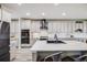 Bright kitchen with white cabinets, subway tile backsplash, stainless steel appliances, and a large island at 7961 E 131St Ave, Thornton, CO 80602