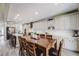 Spacious kitchen with a large center island, white cabinets and adjacent dining table with seating for eight at 7961 E 131St Ave, Thornton, CO 80602