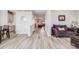 Bright living room featuring wood-look floors, stylish furniture, and a welcoming atmosphere at 7961 E 131St Ave, Thornton, CO 80602
