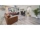 Cozy living room featuring a fireplace, large window, wood flooring, and comfortable seating at 7961 E 131St Ave, Thornton, CO 80602