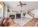 Inviting living room showcasing a fireplace, comfortable seating, and staircase at 7961 E 131St Ave, Thornton, CO 80602