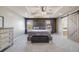 This main bedroom features a tray ceiling, carpeting and barn door to the bath at 7961 E 131St Ave, Thornton, CO 80602