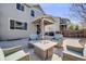 Cozy patio with a fire pit table, comfortable seating, and privacy fence at 7961 E 131St Ave, Thornton, CO 80602