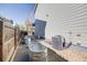 Functional side yard with gravel, metal tubs and AC units neatly arranged along the house at 7961 E 131St Ave, Thornton, CO 80602