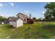 View of the backyard showing the wooden shed, deck, and the home's exterior at 9563 Milwaukee Ct, Thornton, CO 80229