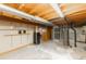 Unfinished basement with a water heater and exposed ductwork and pipes at 9563 Milwaukee Ct, Thornton, CO 80229