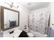 Clean bathroom featuring a vanity, a toilet, and a shower-tub combination with a curtain at 9563 Milwaukee Ct, Thornton, CO 80229