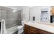 Bathroom features a glass enclosed shower, wood cabinets, and tile flooring at 9563 Milwaukee Ct, Thornton, CO 80229
