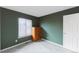 Empty bedroom showing a large window, chest of drawers, and neutral-colored carpet at 9563 Milwaukee Ct, Thornton, CO 80229