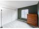 Empty bedroom showing a large window, spacious closet, and neutral-colored carpet at 9563 Milwaukee Ct, Thornton, CO 80229