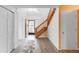 Bright foyer featuring wood staircase and an exterior door with decorative security bars at 9563 Milwaukee Ct, Thornton, CO 80229