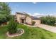Charming two-story home featuring a landscaped front yard with green grass and mature trees at 9563 Milwaukee Ct, Thornton, CO 80229