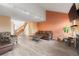 Spacious living room featuring an open layout, comfortable seating, and a staircase at 9563 Milwaukee Ct, Thornton, CO 80229