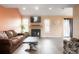 Comfortable living room with a fireplace, wood floors, and ample natural light from the windows at 9563 Milwaukee Ct, Thornton, CO 80229