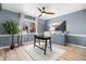 Bright home office features wood-look flooring, built-in shelving, and a large window at 3346 S Quintero St, Aurora, CO 80013