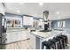 Modern kitchen with white cabinets, granite island, and stainless steel appliances at 3346 S Quintero St, Aurora, CO 80013