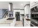 Modern kitchen with stainless steel appliances, granite countertops, and white cabinets at 3346 S Quintero St, Aurora, CO 80013