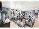 Bright and airy living room with hardwood floors, ample seating, and a view of the staircase at 3346 S Quintero St, Aurora, CO 80013