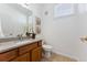 Powder room with a granite countertop, wood vanity, and tile flooring at 9980 W Jewell Ave # B, Lakewood, CO 80232