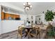 Open dining area adjacent to the kitchen and living room, featuring a modern chandelier at 9980 W Jewell Ave # B, Lakewood, CO 80232