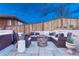 Relaxing backyard featuring a stone patio, a fire pit, and comfortable wicker seating at 10104 Nadine Ave, Parker, CO 80134