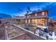 Exterior view of the backyard showcasing deck, hot tub, outdoor seating, lush lawn, and garden beds at 10104 Nadine Ave, Parker, CO 80134
