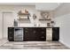 Stylish basement bar area featuring custom cabinets, open wood shelving, and wine storage at 10104 Nadine Ave, Parker, CO 80134