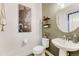 Stylish powder room with pedestal sink, updated fixtures, and elegant decor at 10104 Nadine Ave, Parker, CO 80134
