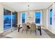 Elegant dining room featuring a large window, stylish chandelier and access to the backyard at 10104 Nadine Ave, Parker, CO 80134