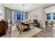Formal dining room with a dark wood table, chandelier, and neutral paint scheme at 10104 Nadine Ave, Parker, CO 80134