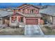 Charming two-story home with a well-manicured front yard, stone accents, and an attached two-car garage at 10104 Nadine Ave, Parker, CO 80134