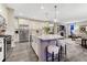 Beautiful kitchen with island and stainless steel appliances that flows into living room at 10104 Nadine Ave, Parker, CO 80134