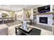 Open concept living room with a fireplace, kitchen, and stairs to a second level at 10104 Nadine Ave, Parker, CO 80134