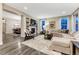 Open-concept living room with a fireplace and a view into the dining room at 10104 Nadine Ave, Parker, CO 80134