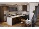 Modern kitchen with stainless steel appliances, an island with seating, and stylish contrasting cabinetry at 5780 W 92Nd Ave, Westminster, CO 80031