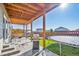 Covered patio with grill, fire pit, and trampoline in fenced backyard at 803 William Way, Brighton, CO 80603