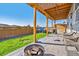 Relaxing backyard with covered patio, fire pit, and room for play at 803 William Way, Brighton, CO 80603