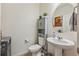 Small bathroom with pedestal sink and linen cabinet at 803 William Way, Brighton, CO 80603
