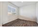 Simple bedroom with wood-look floors and a window at 803 William Way, Brighton, CO 80603