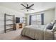 Spacious bedroom with large window, built-in shelving, and ceiling fan at 803 William Way, Brighton, CO 80603