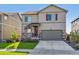 Two-story house with a two-car garage and landscaped lawn at 803 William Way, Brighton, CO 80603
