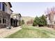 Expansive backyard with lush green lawn, mountain views, and stone accents at 16791 W 48Th Ln, Golden, CO 80403