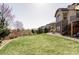 Extensive backyard with a lawn and a home with stone accents in a neighborhood at 16791 W 48Th Ln, Golden, CO 80403