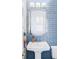 Stylish bathroom featuring blue tiled walls, an elegant mirror, and a sleek vanity at 16791 W 48Th Ln, Golden, CO 80403