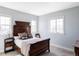 Comfortable bedroom featuring a wooden bed, soft lighting, and neutral decor at 16791 W 48Th Ln, Golden, CO 80403