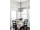 Cozy dining area with table set for four people with views through the windows and patio doors at 16791 W 48Th Ln, Golden, CO 80403