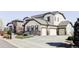 A beautiful stucco and stone home with a three-car garage and a large driveway is featured at 16791 W 48Th Ln, Golden, CO 80403