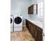 This laundry room offers lots of storage with washer, dryer, sink and many cabinets at 16791 W 48Th Ln, Golden, CO 80403