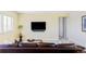Cozy living room with leather sofa, television, and view to the hallway at 16791 W 48Th Ln, Golden, CO 80403