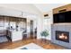 Open concept living room with modern fireplace, hardwood floors, and kitchen island at 16791 W 48Th Ln, Golden, CO 80403